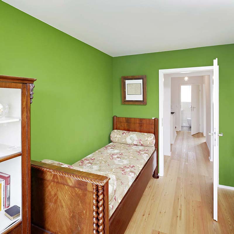 Gästezimmer mit grünen Wänden.